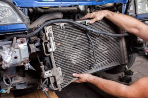 Disassembly of an old and worn car radiator by a mechanic